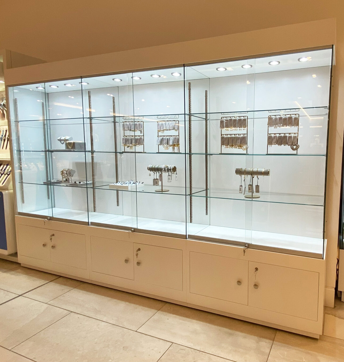 Wide glass display Cabinet with lockable storage and led lights.