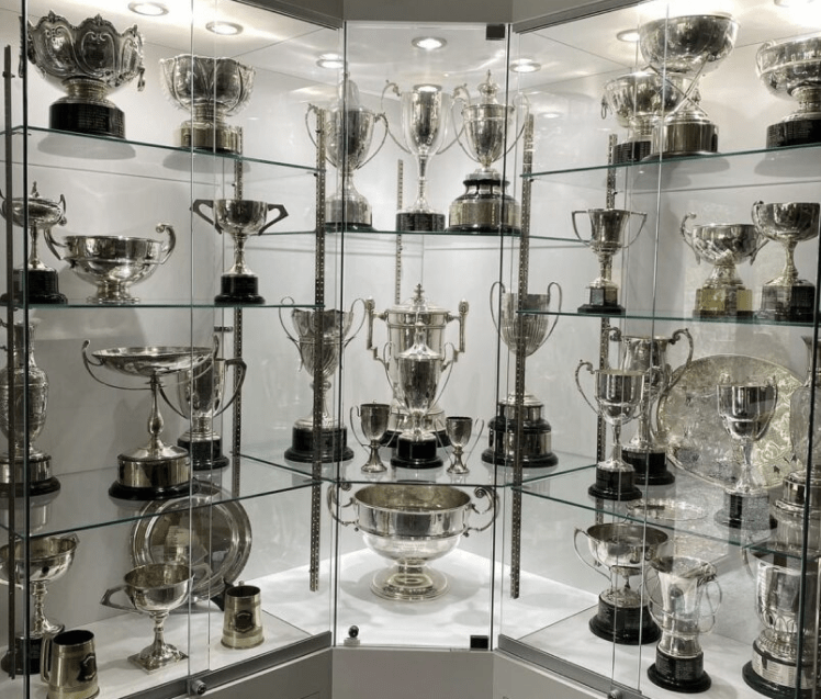 Glass display cabinet showcase with trophies and collectibles