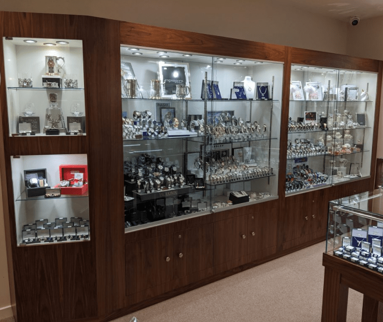 Glass display cabinet showcase with trophies and collectibles